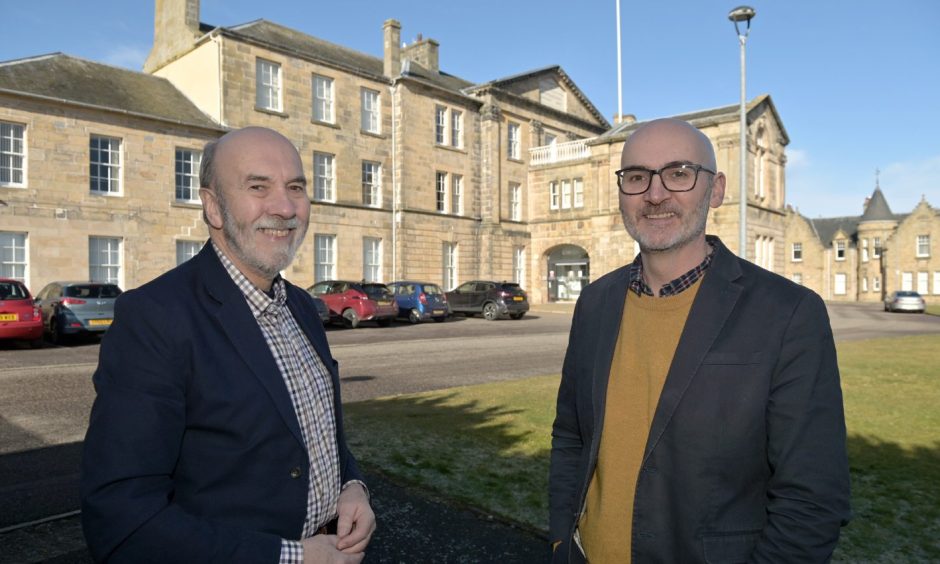 Jim Leslie (left) and  his son Prof Steve Leslie at the old Royal Northern Infirmary building in Inverness. Image Sandy McCook/DC Thomson