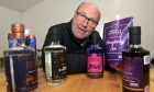 David Morrison, owner of Roehill Springs Distillery, with some of his products. Image: Sandy McCook/DC Thomson