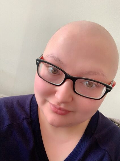 A selfie of Kirsty with no hair and glasses during her chemo treatment