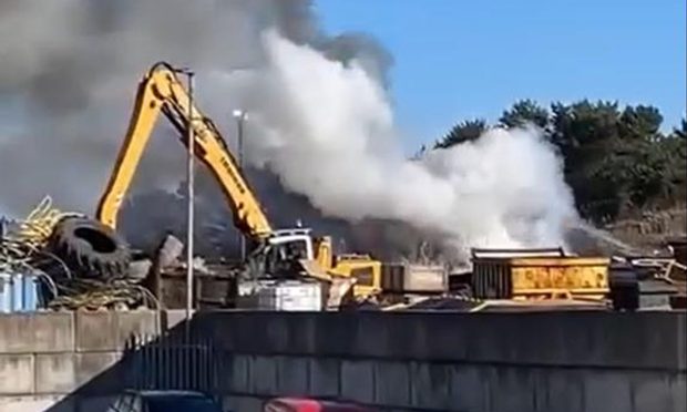 Fire crews workind into the afternoon to put out the blaze in Peterhead's Damhead Circle industrial estate. Image: Peterhead Live.