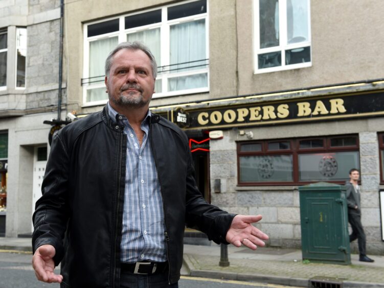 Bob Baxter, dressed in a leather jacket and blue shirt, pictured outside Cooper Bar.