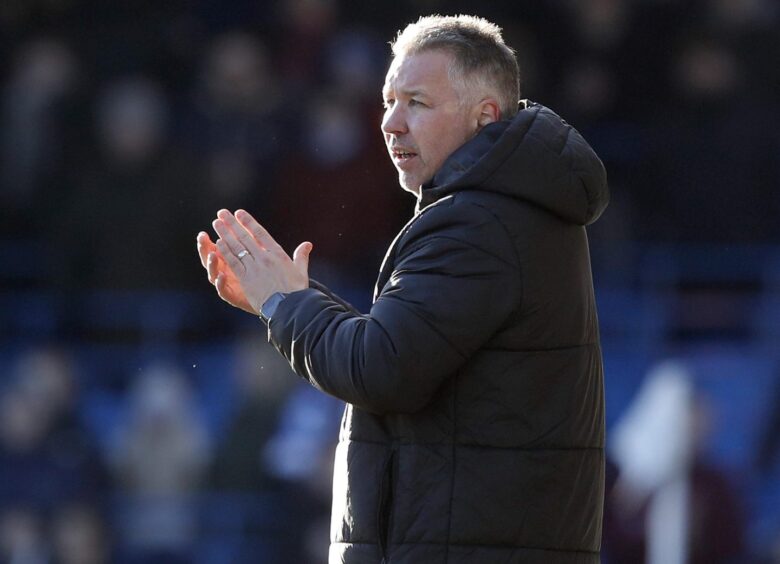 Peterborough United manager Darren Ferguson clapping at the side of the pitch