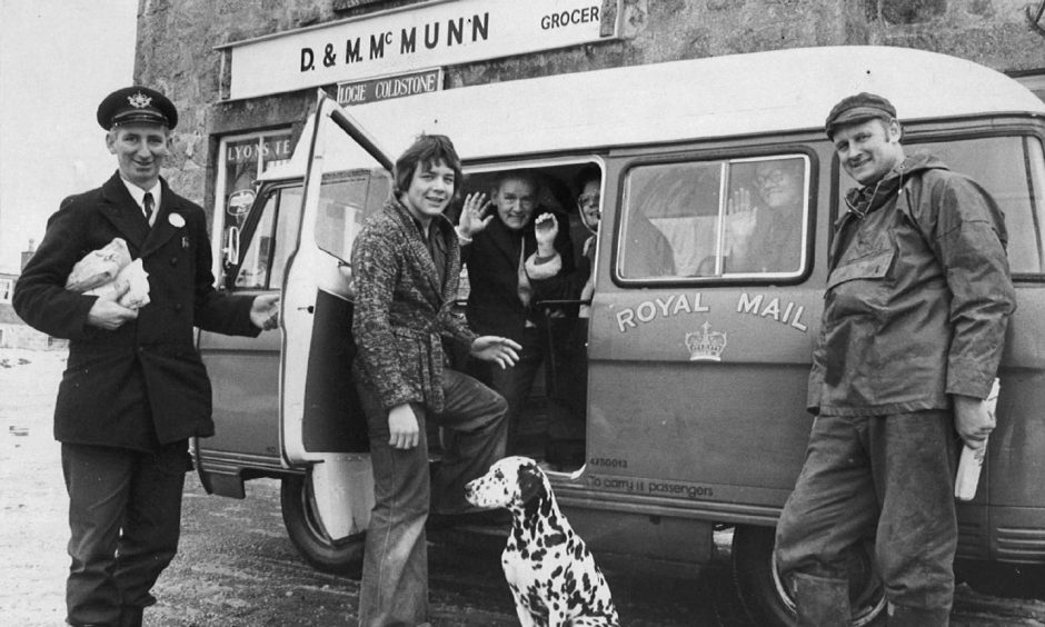 Driver/postie Brian Niven, left, and locals boarding a Royal Mail post bus at Logie-Coldstone.