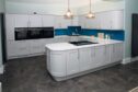 model kitchen with pristine white cabinets by Duncans Kitchens which does kitchen renovations in the UK