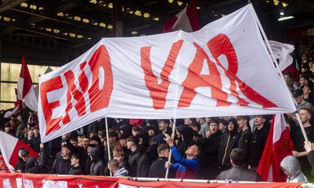 Aberdeen fans hold a sign "END VAR" during a Premiership match with Dundee on April 13. Image: Shutterstock.