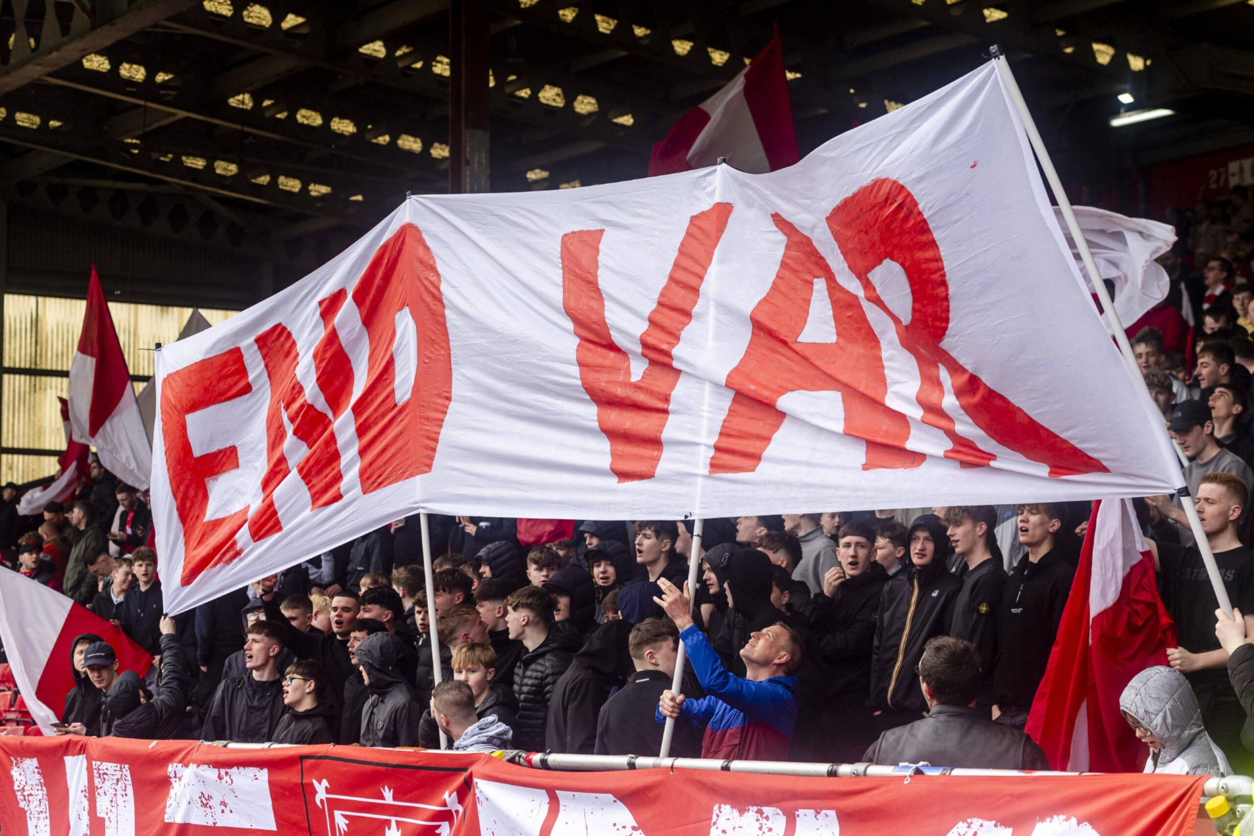 Aberdeen fans hold a sign "END VAR" during gameplay of Scottish Premiership match Aberdeen vs Dundee at Pittodrie.. Image: Shutterstock 
