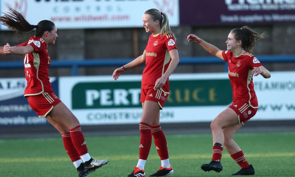 Aberdeen Women wing-back Hannah Innes, centre, celebrates with her team-mates after scoring in the SWPL match against Montrose.