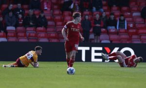 Jack Vale of Motherwell and Jack MacKenzie of Aberdeen grounded following Vale's challenge. Image: Shutterstock.