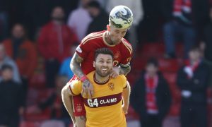 Angus MacDonald of Aberdeen and Motherwell's Blair Spittal battle for the ball. Image; Shutterstock