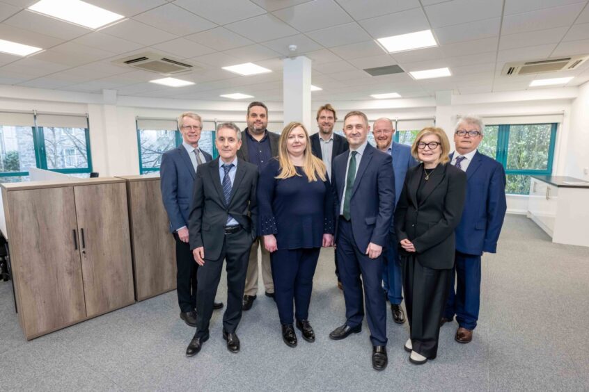 Some of the expanded team at Burnett & Reid. Colin Bremner is on the far left in the front row. Frank Mathers is on the far left in the back row, with Neil Johnston second from the right at the back.