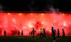 The use of pyrotechnics - like those which held up a game at Dens Park earleir this season - was slammed by the sheriff. Image: Ross Parker / SNS Group)