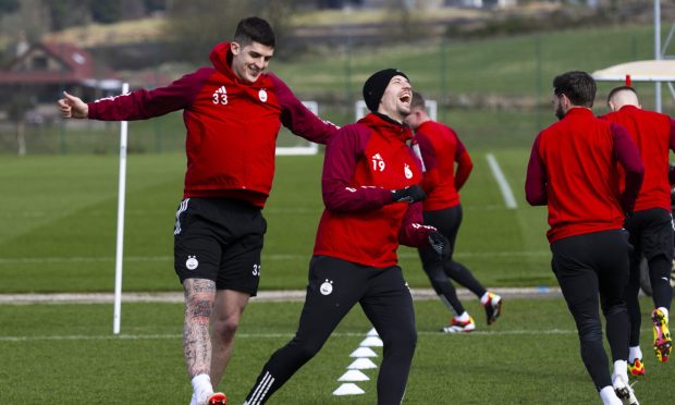 Aberdeen defender Slobodan Rubezic (L) and Ester Sokler (C) during a training session at Cormack Park, on March 29. Image: SNS