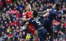 Aberdeen's Angus MacDonald and Dundee's Joe Shaughnessy in action. Image: SNS