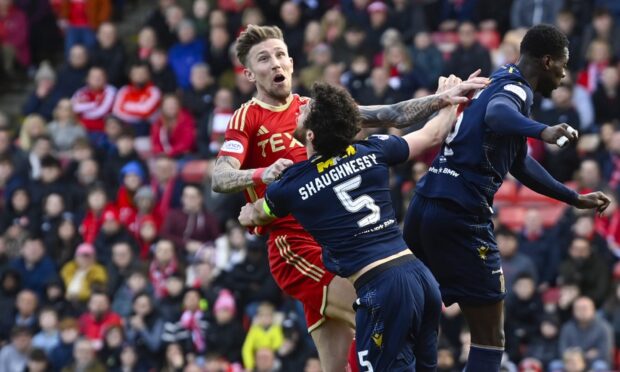 Aberdeen's Angus MacDonald and Dundee's Joe Shaughnessy in action. Image: SNS