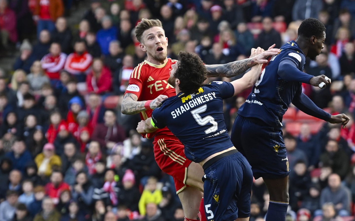  Aberdeen's Angus MacDonald and Dundee's Joe Shaughnessy in action. Image: SNS 