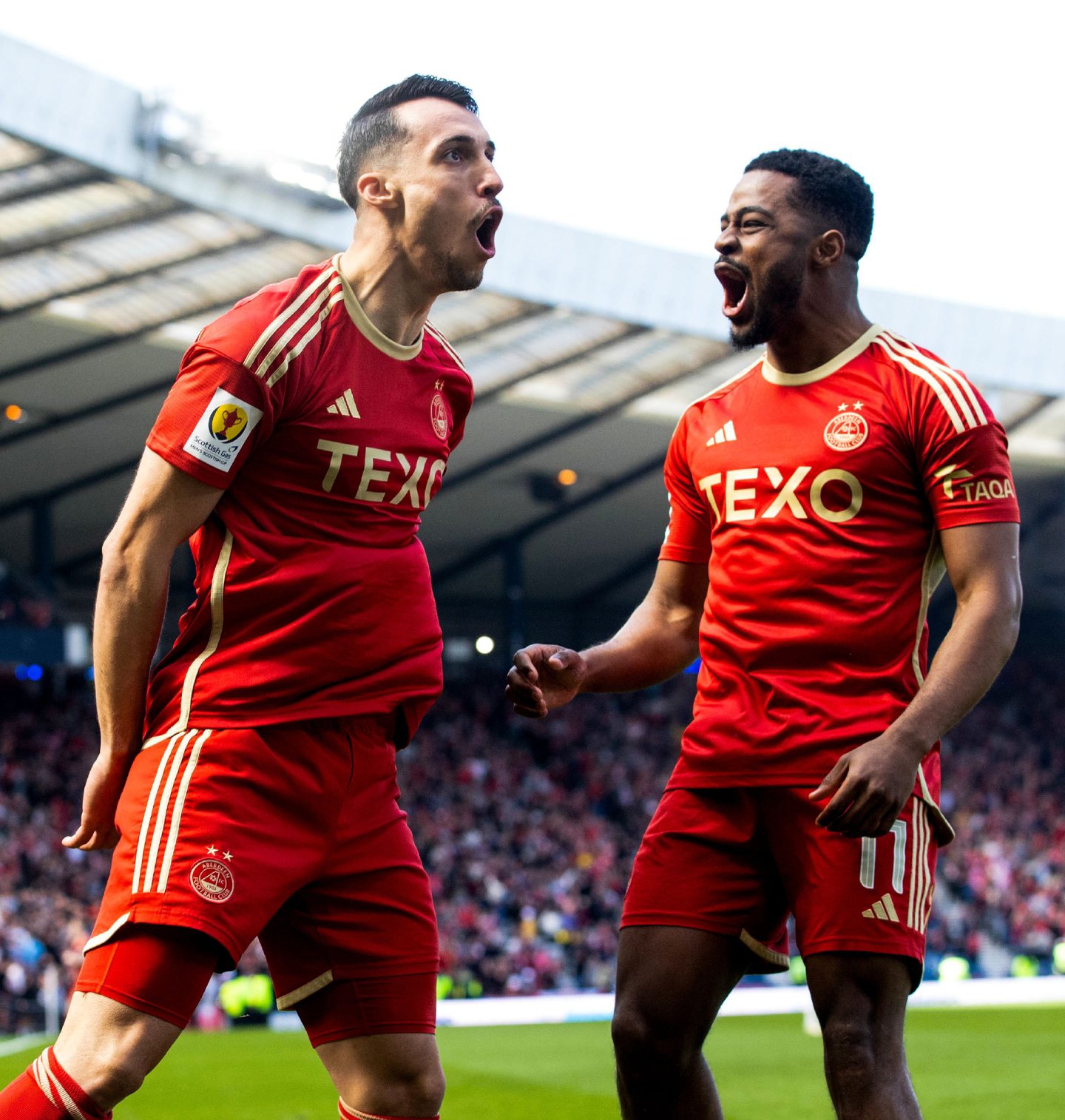 Bojan Miovksi celebrates with Duk on the pitch, both of whom have had transfer speculation