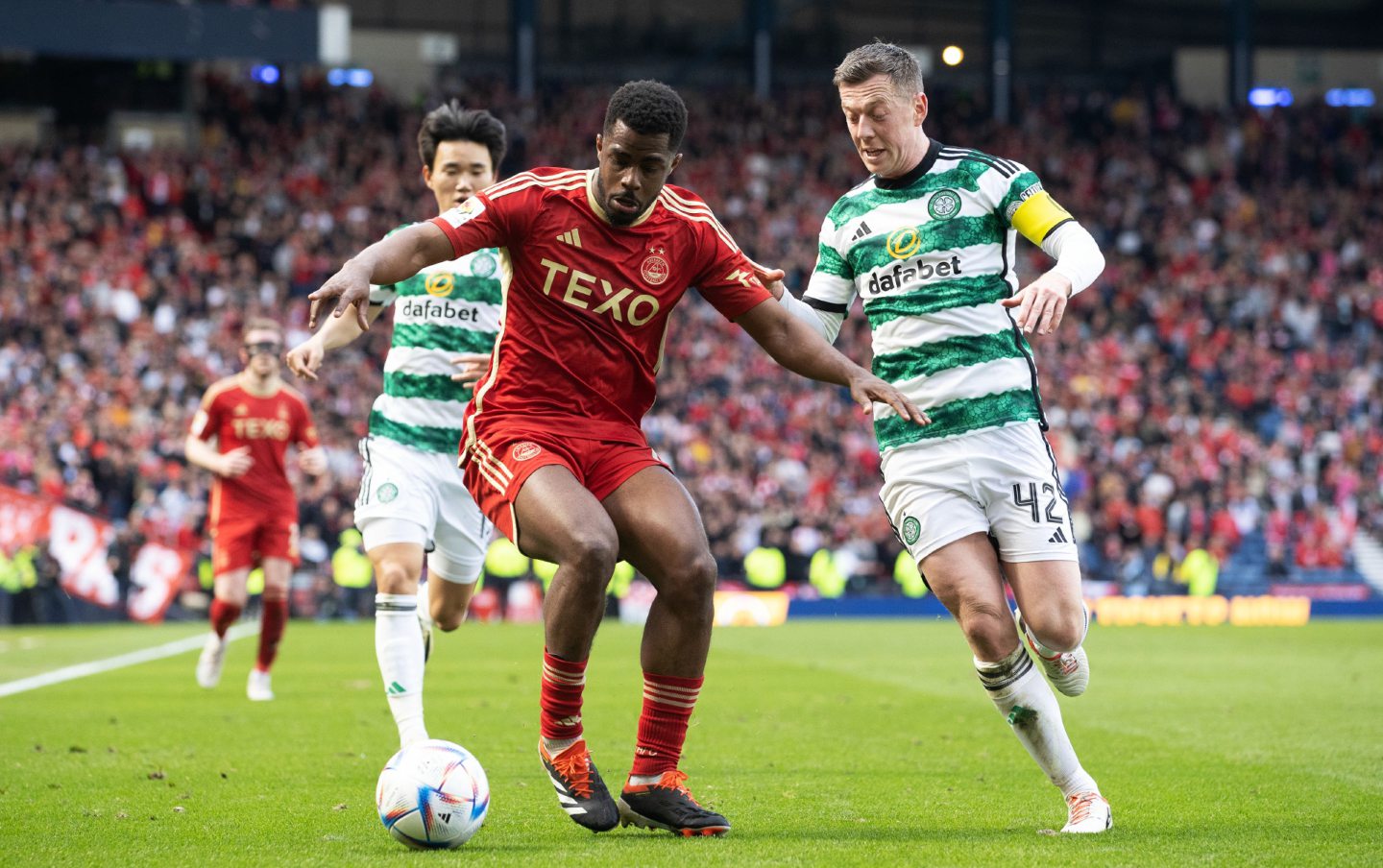 Aberdeen's Duk holds off Celtic's Callum McGregor and Yang Hyun-Jun during the Scottish Gas Scottish Cup semi-final match at Hampden in April.