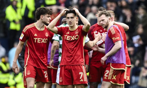 Aberdeen players are dejected at full time after the penalty shoot-out loss to Celtic. Image: SNS