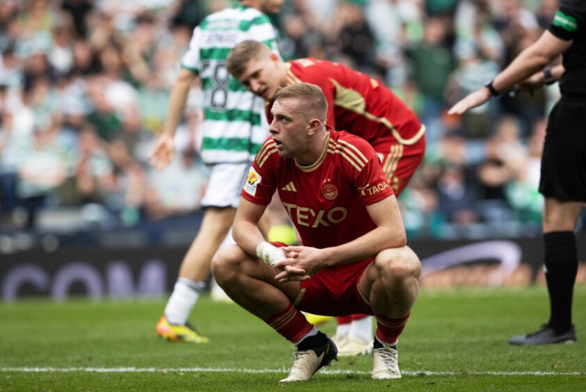 Killian Phillips squats on the Hampden turf after seeing his penalty saved by Celtic goalkeeper Joe Hart. 