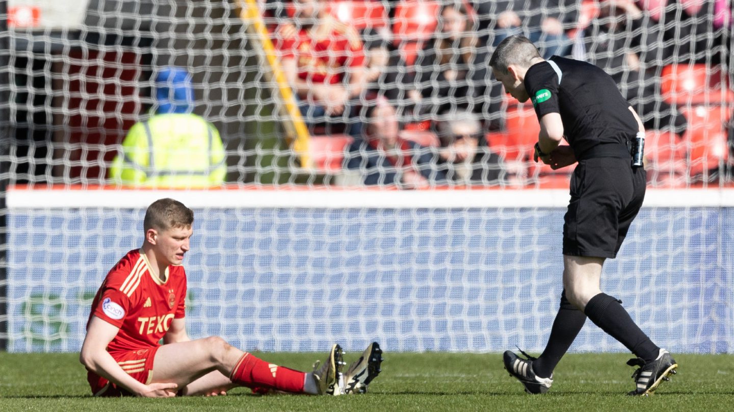 Aberdeen's Jack MacKenzie goes down injured during the 1-0 defeat of Motherwel. Image: SNS 