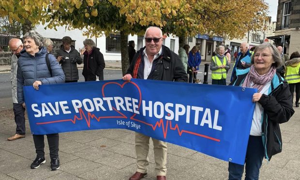 Campaigners want the A7E in Portree to be open 24 hours. Pictured is a campaign banner as it makde its way through Portree.