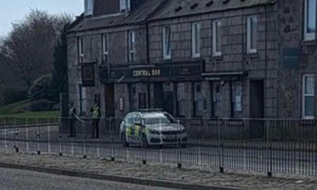 Police car and officers outside Central Bar in Aberdeen