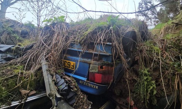 Renault 19 from the 1980s abandoned in the woods.