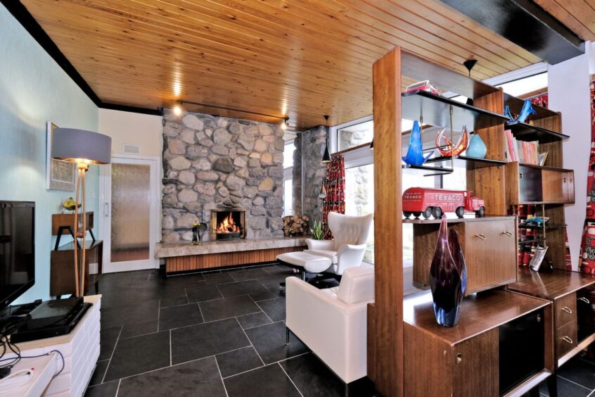 Exposed stone and slate flooring in the living area of the mid-century modern home for sale near Balmedie.
