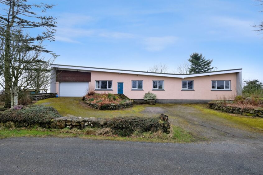 Exterior of the mid-century modern home near Balmedie, featuring a butterfly roof.