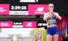 Mhairi Maclennan reacts after finishing the women's elite race during the TCS London Marathon on Sunday. Image: PA.