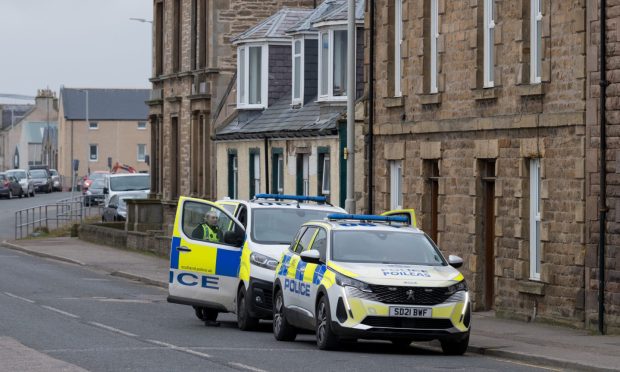 Police cars on Church Street in Buckie after an assault