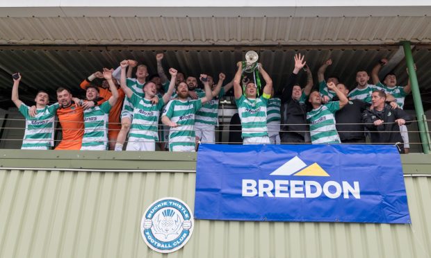 20 April 2024. Buckie Thistle FC, Victoria Park, 9 Midmar Street, Buckie, Moray, Scotland, AB56 1PP. This is from the Breedon Highland League Match between Buckie Thistle FC and Keith FC.  PICTURE CONTENT:- Buckie captain Sam Pugh lifts the Highland League trophy       CREDIT:- JASPERIMAGE
