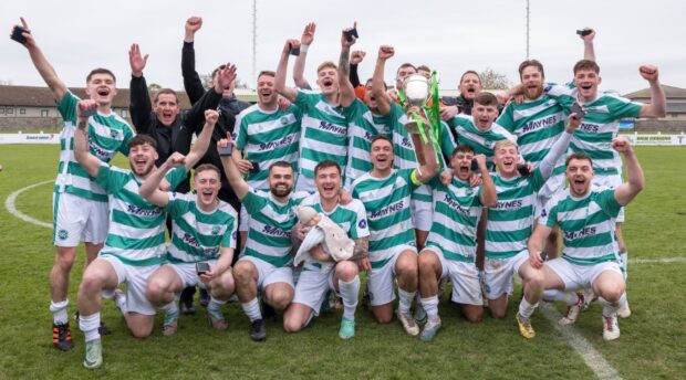 Banks o' Dee captain Kane Winton, left, lifts the Highland League Cup after Saturday's final. Image: Darrell Benns/DC Thomson