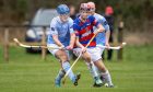 Ruairidh MacKinnon (Caberfeidh) with Cameron Bremner (Kingussie).  Image: Neil Paterson.