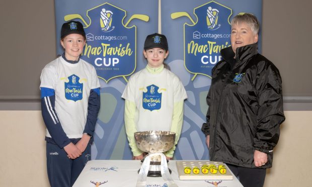 Maisie Ewing and Taylor Cameron (Kilmallie) alongside Heather Grant from sponsors cottages.com after the MacTavish Cup quarter-final draw.  Supplied by Camanachd Association.