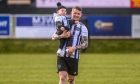 Ryan Cowie holding his son Hudson following his last game for Fraserburgh at the weekend. Picture by Darrell Benns/DCT Media.
