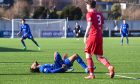 Cove Rangers striker Rumarn Burrell went down injured in the League One win over Stirling Albion.