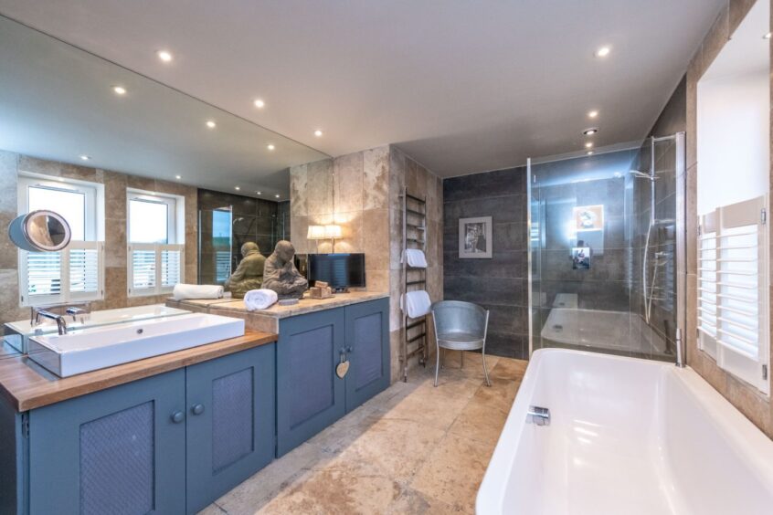 Another bathroom in the seaside property in Aberdeenshire, featuring shower and bathtub. 