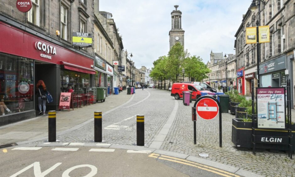 Mock-up image showing bollards blocking entrance to Elgin High Street outside Costa.