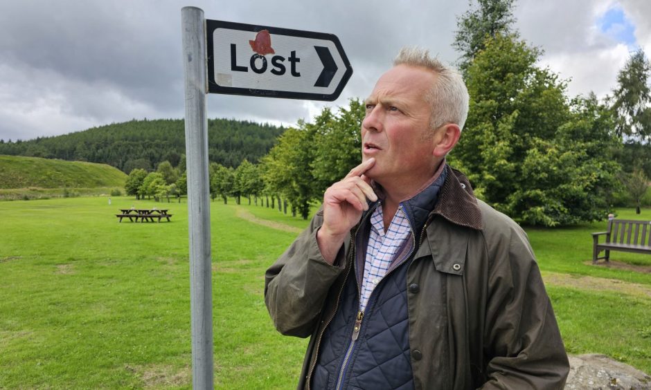 Jules Hudson next to "Lost" sign 