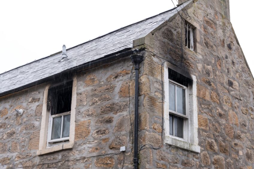 Soot around windows on the exterior of the Forres house.