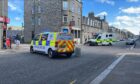 Police and paramedics on the scene at George Street this afternoon. Image: DC Thomson.