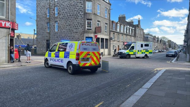 Police and paramedics on the scene at George Street this afternoon. Image: DC Thomson.