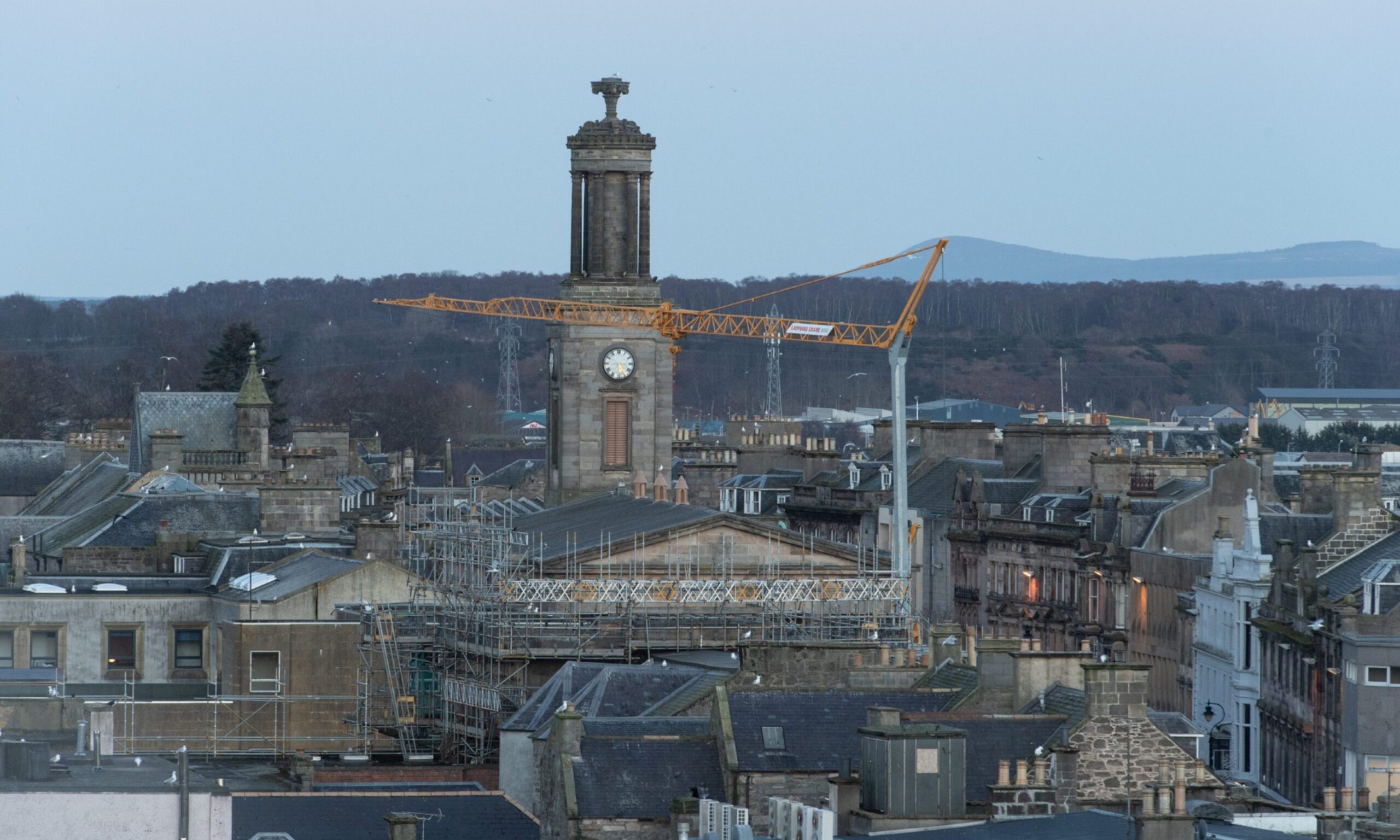 Crane towering over Elgin High Street viewed from Ladyhill. 
