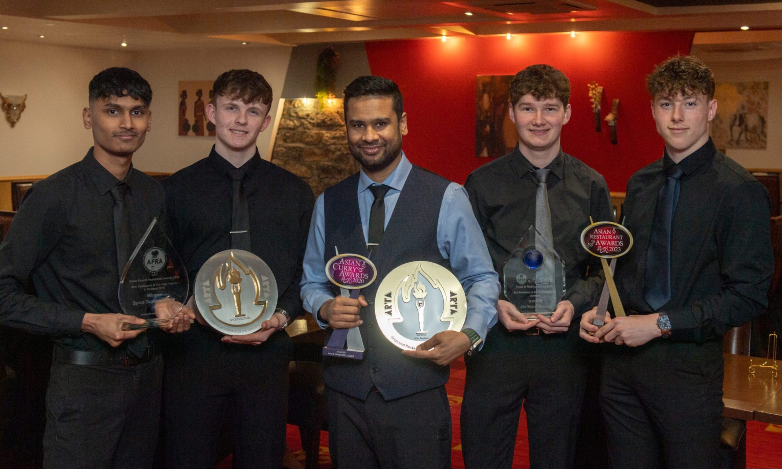 Spice Tandoori team holding awards.