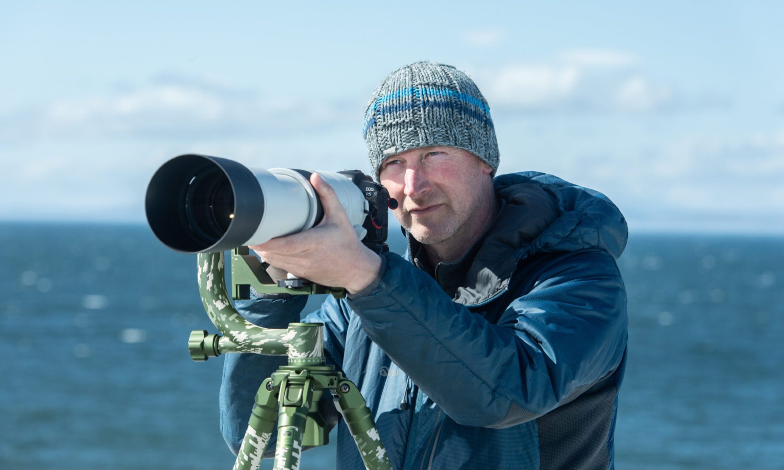 Steve Truluck looking through telescopic photo lens. 