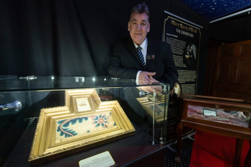 Collector John White standing in the exhibition