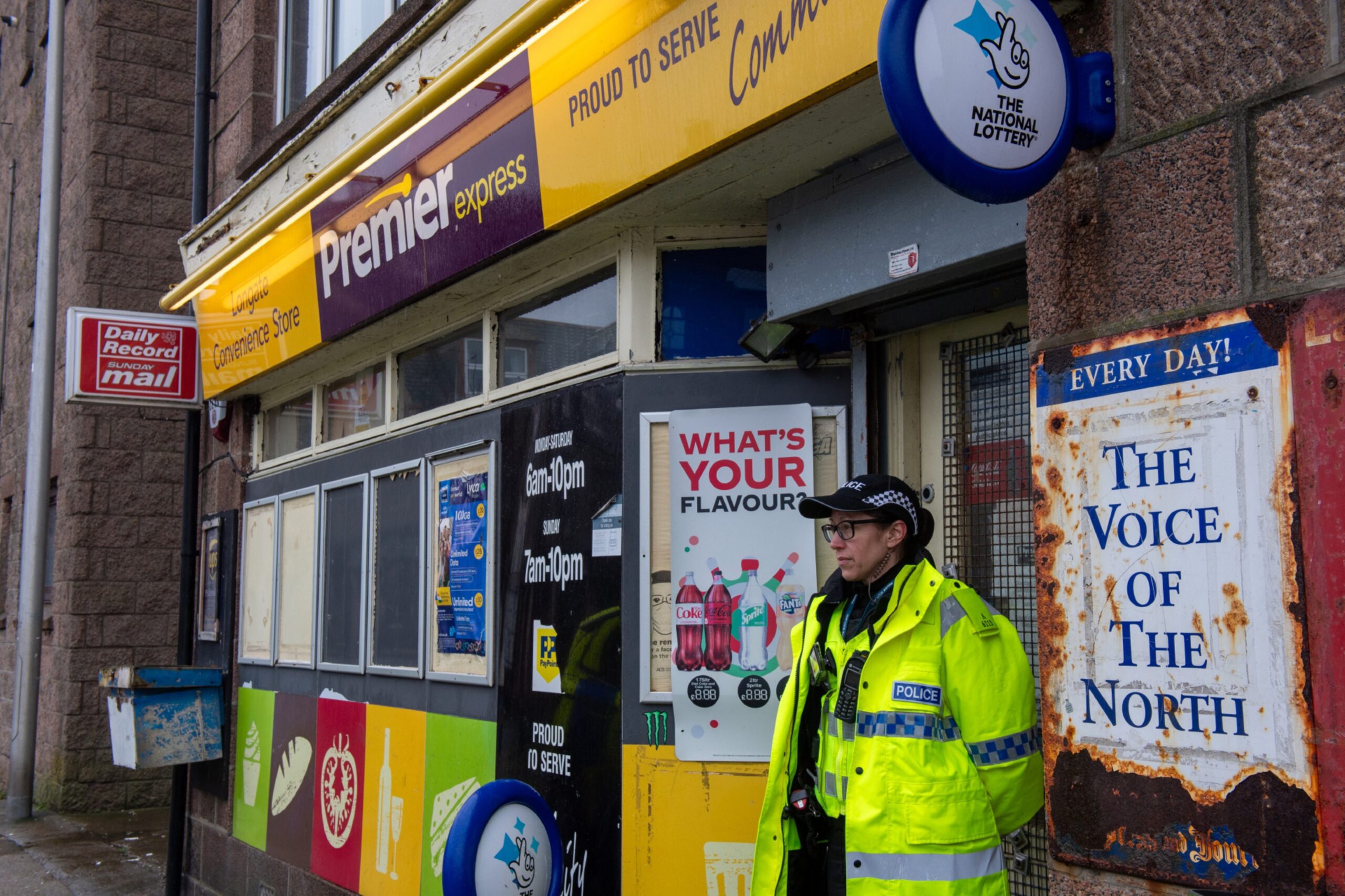 Police officer outside the Premier shop in Peterhead.