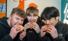 Josh Sim, Nathan Johnston and Vincent Choi - the lucky winners of free chicken sandwiches for a year. Image: Kenny Elrick/DC Thomson.