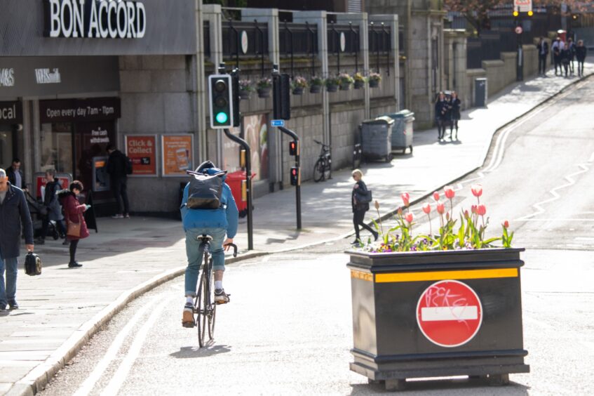 A cyclist zips through on the westbound bike lane in Upperkirkgate. Image: Kami Thomson/DC Thomson